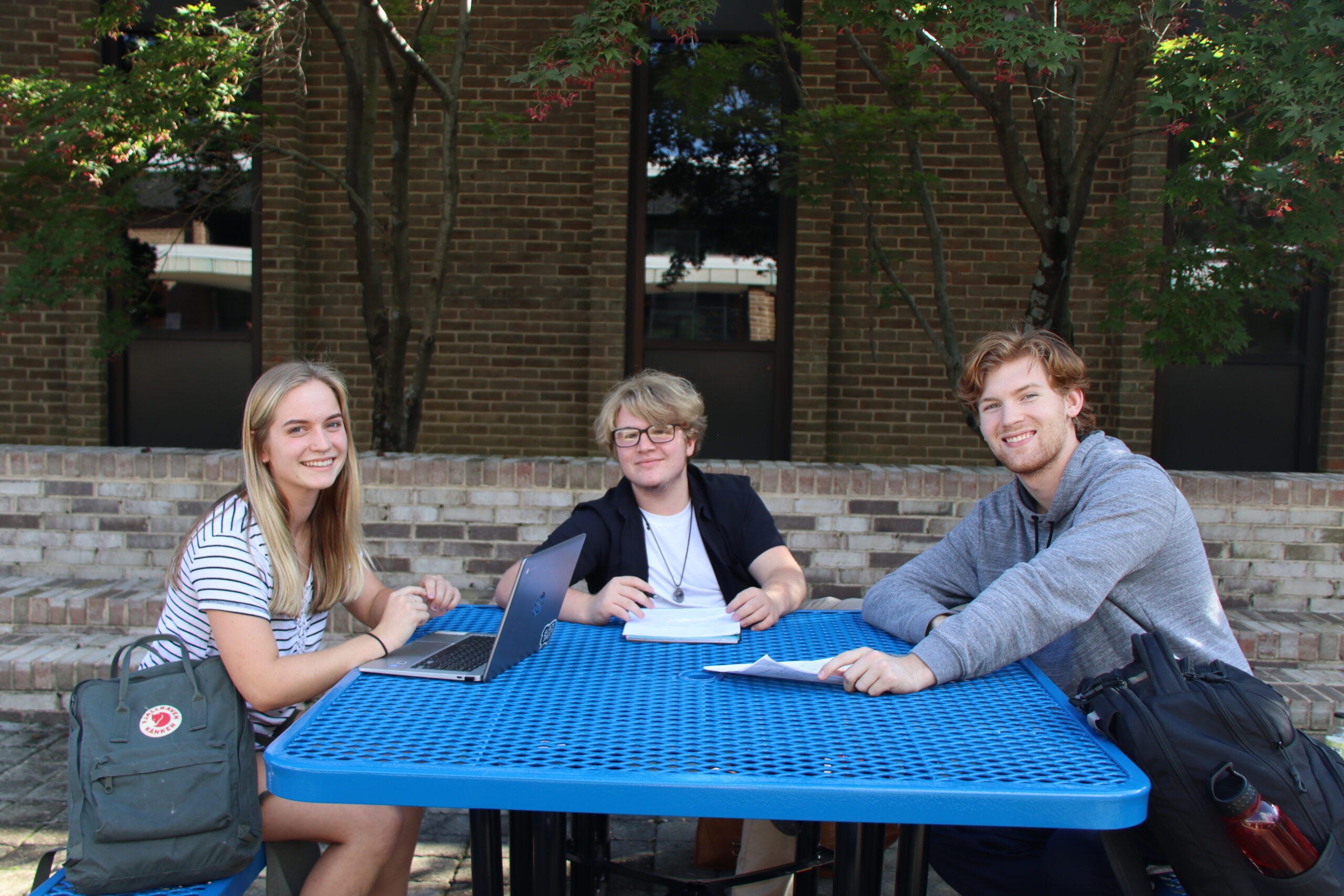students at table outside