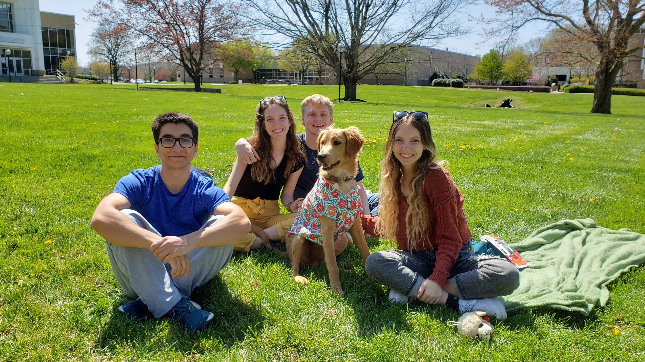 students with dog on Quad