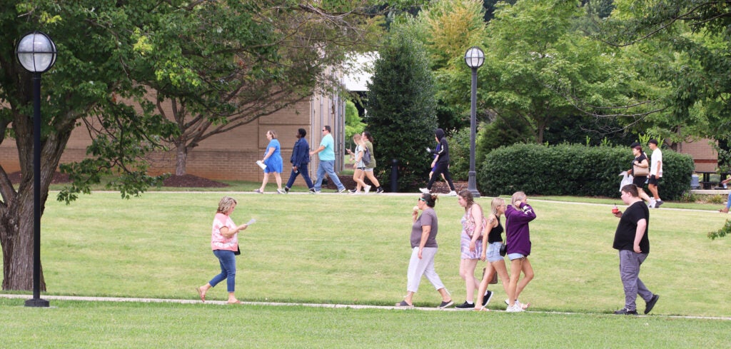 Groups of students walk to and fro on the quad