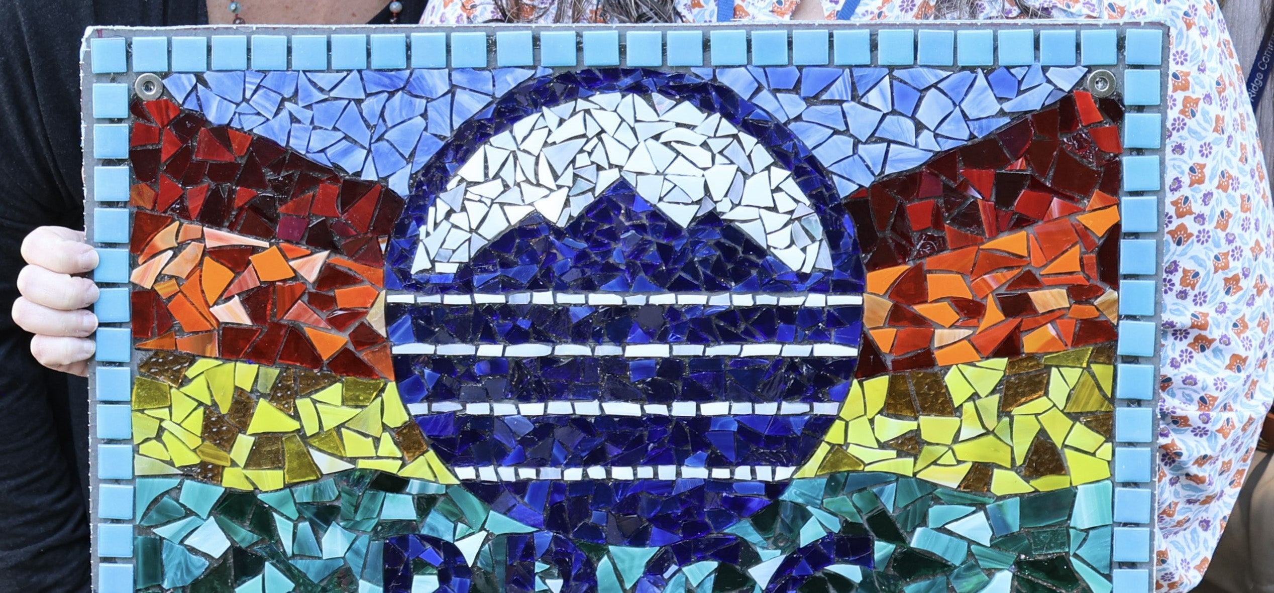 Mosaic with BRCC logo and rainbow colored mountains