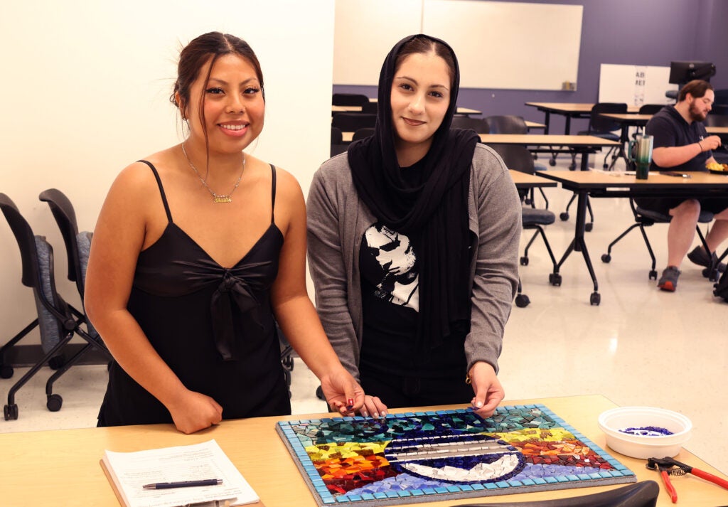 Two women students working on the mosaic