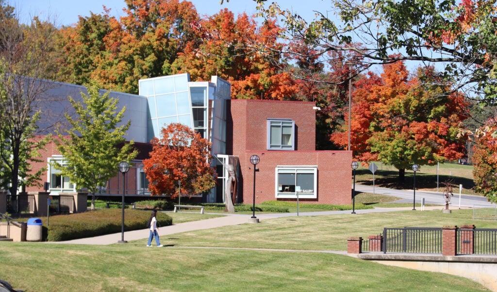 Fine Arts building seen from the commons in fall, with walking bridge at the right