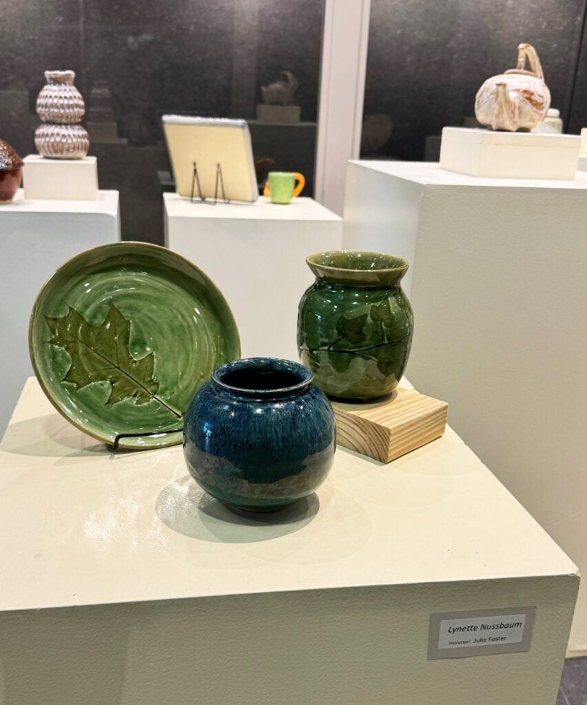 Green plate with a leaf design, blue vase, green vase with leaves