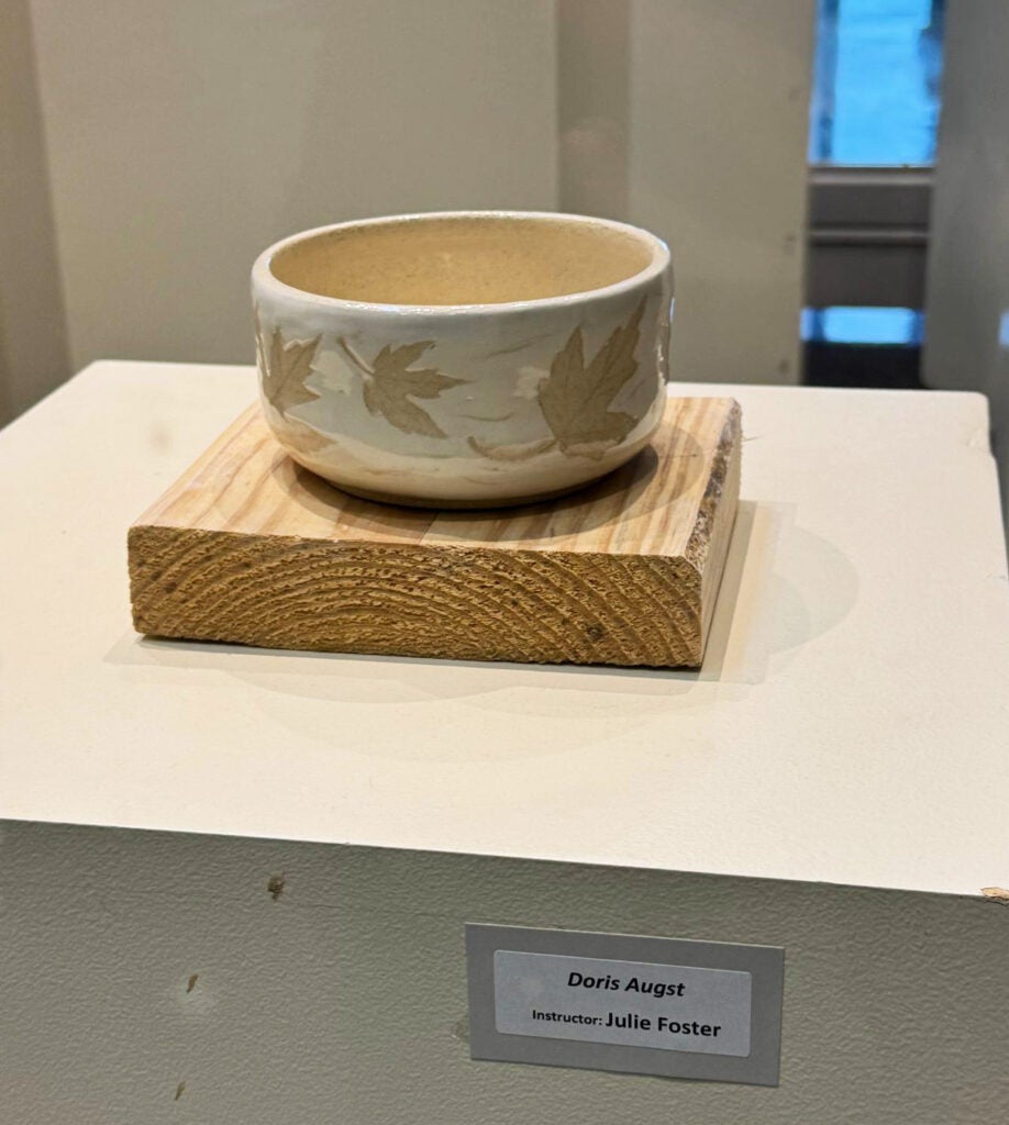 white bowl with yellow maple leaves decoration on the outside