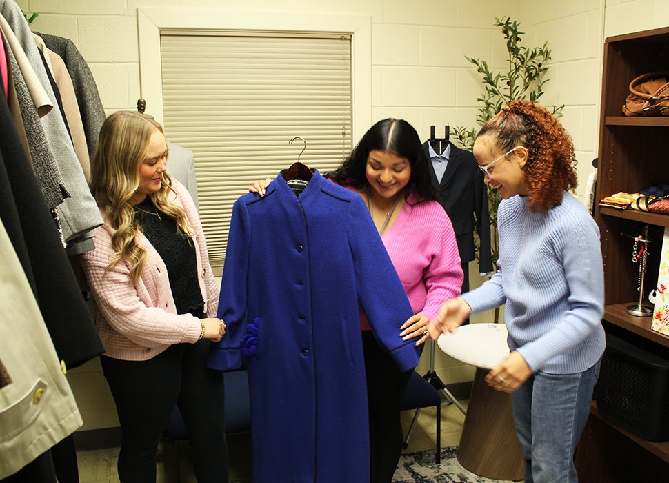 Student women selecting a suit jacket in the Student Success Center