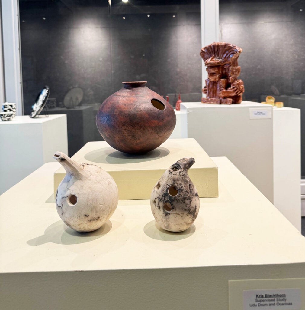 a rust-colored udu drum and two raku fired ocarinas