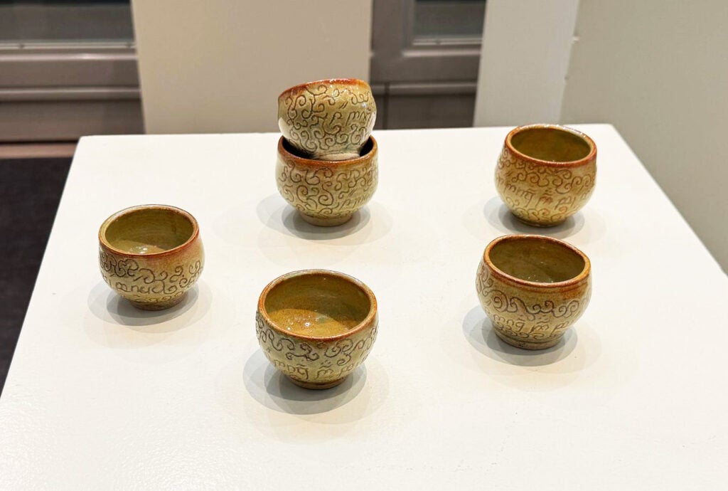 small cups with swirl motif and tengwar writing